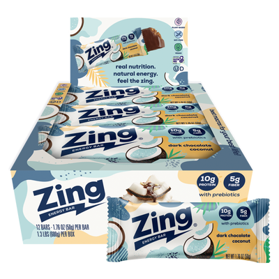 A box of Zing Energy Bar snack sticks with two individual bars displayed in front on a plain white background. The packaging features light blue, white, and yellow graphics with coconut illustrations and text indicating dark chocolate coconut flavor and prebiotics.